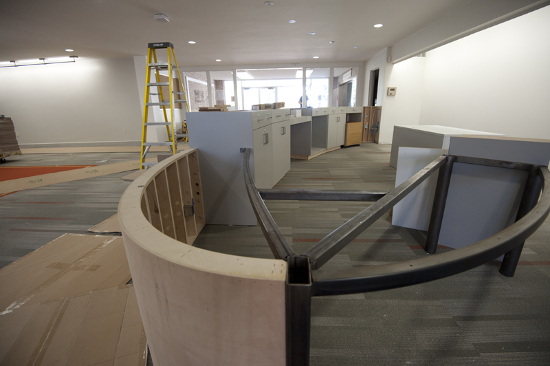 The skeleton of the new reference desk, with a modern, curved style, is in place.