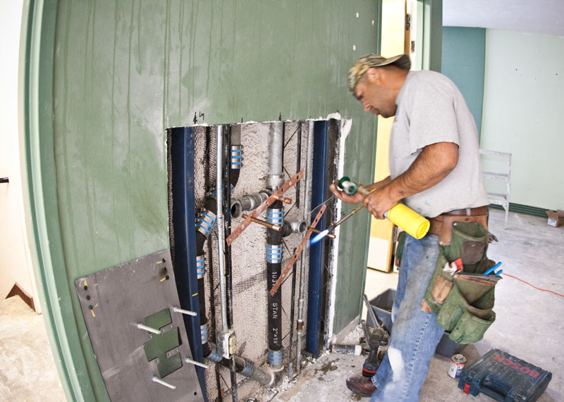 Workers tore into the walls to update the library’s plumbing.